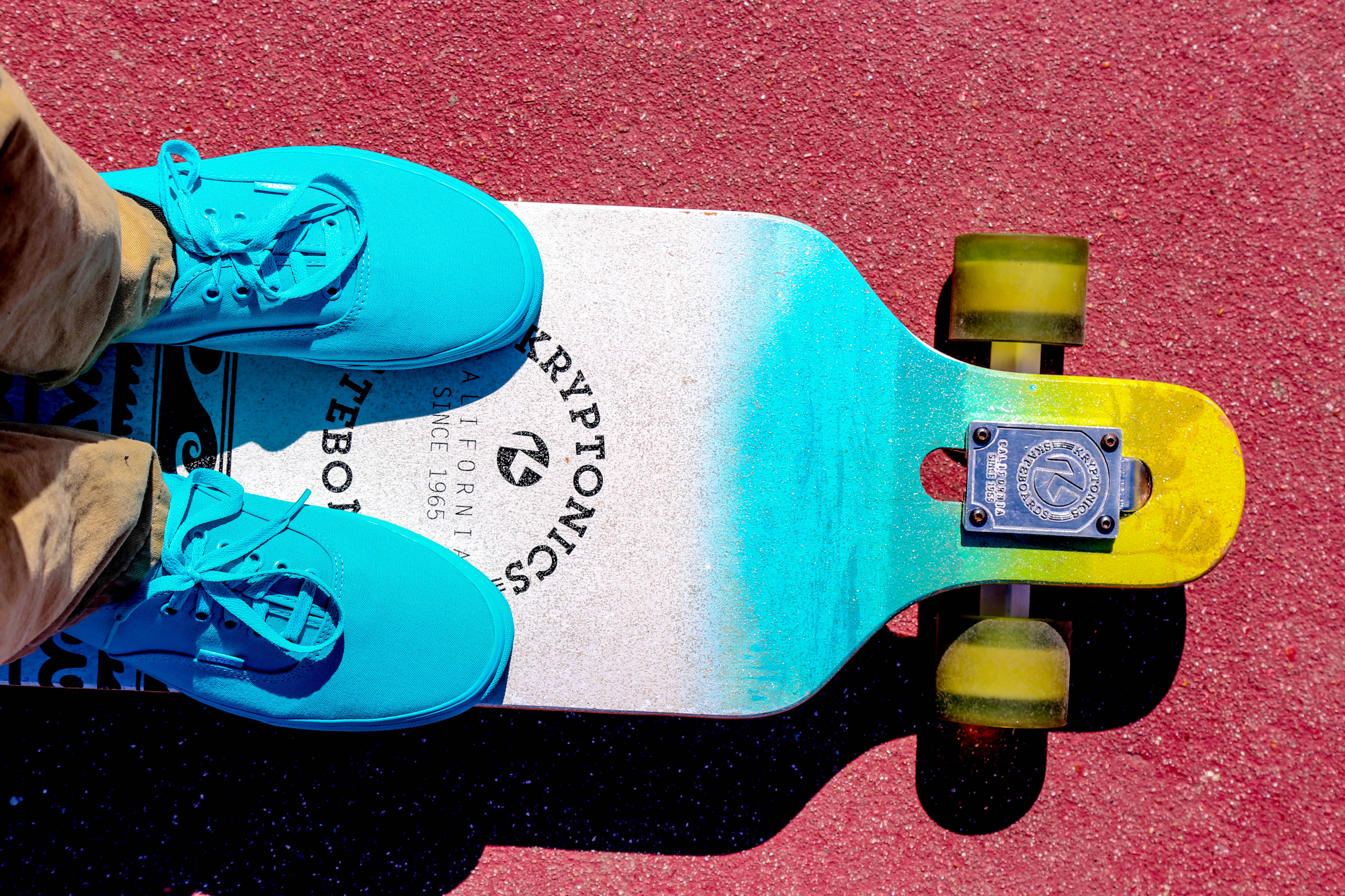 blue shoes on a crusier longboard